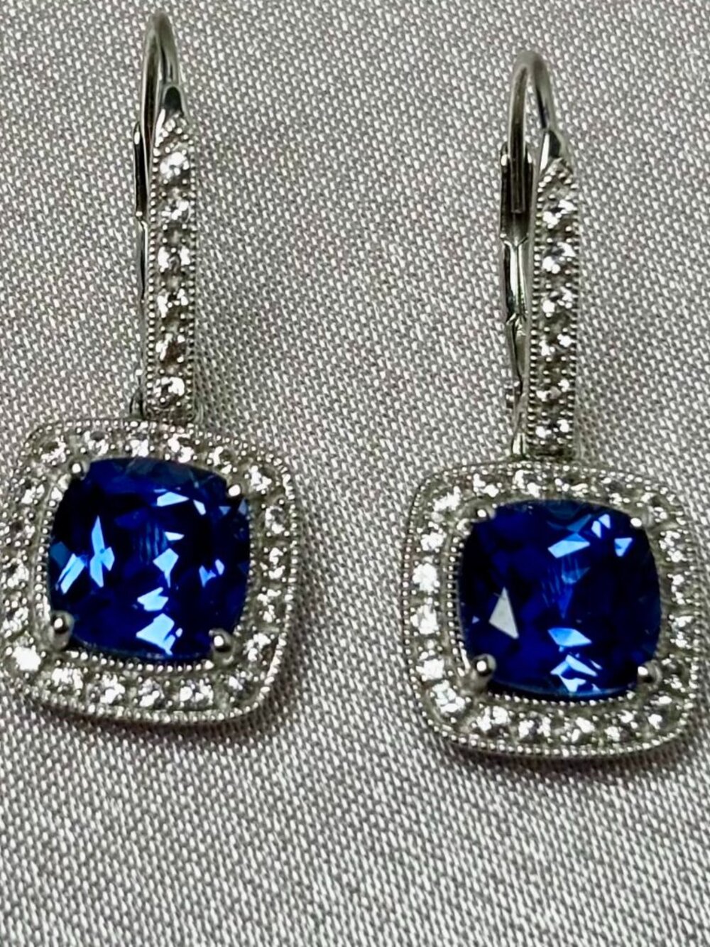 Diamonds and cushion cut intense midnight blue sapphire 14k white gold earring.